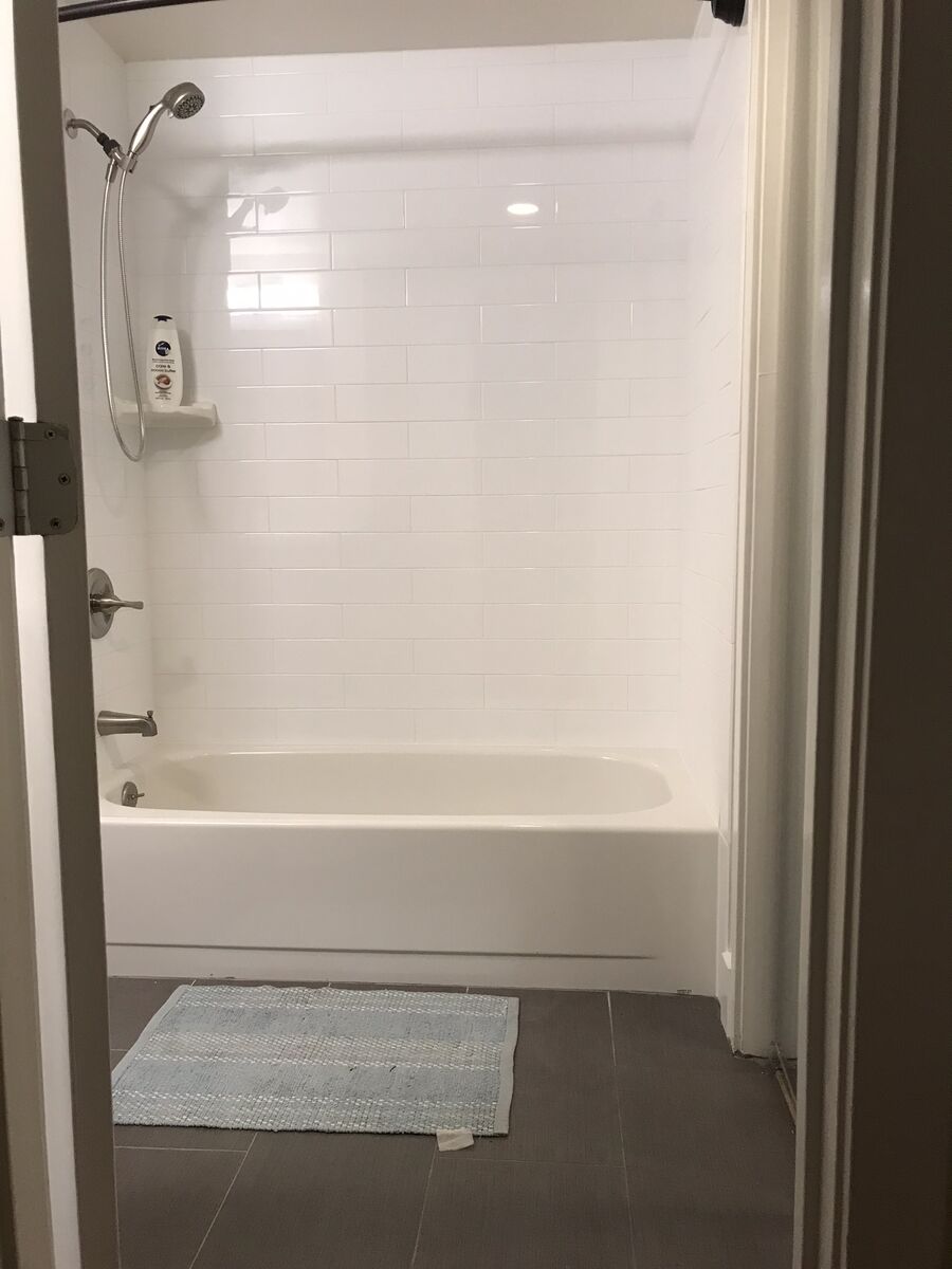 Remodeled tiled shower with grab bars