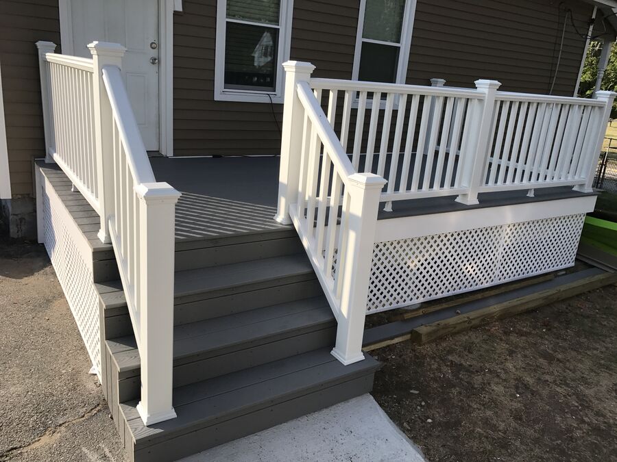 Completed composite deck with white railings and lattice skirt